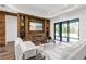 Living room with stone fireplace, comfortable white seating, and access to the backyard at 4308 Fly Rod Ter, Parrish, FL 34219