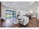Open concept living area with sofa and modern kitchen in the background at 4308 Fly Rod Ter, Parrish, FL 34219