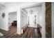 Bright mudroom with built-in storage bench, coat hooks, wood floors with stone accent wall at 4308 Fly Rod Ter, Parrish, FL 34219