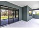 Covered patio with sliding glass doors and a dark exterior offering views of the backyard at 4308 Fly Rod Ter, Parrish, FL 34219