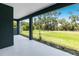 The covered patio overlooks the spacious green backyard with mature trees, perfect for relaxing at 4308 Fly Rod Ter, Parrish, FL 34219