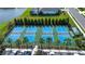 Aerial view of four well-maintained community pickleball courts with lush landscaping and nearby parking at 4308 Fly Rod Ter, Parrish, FL 34219