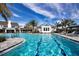 Lap pool with clear blue water, lounge chairs, and lush landscaping is great for recreation and relaxation at 4308 Fly Rod Ter, Parrish, FL 34219