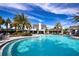 Community pool surrounded by lounge chairs and tropical palms offers a relaxing oasis for residents at 4308 Fly Rod Ter, Parrish, FL 34219