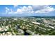 Wide aerial view showcases a community with varied housing, green spaces, and waterways under a partly cloudy sky at 4325 46Th W Ave # 202, Bradenton, FL 34210