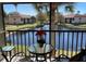 Relaxing screened balcony with a view of the lake, complete with a table and chairs for outdoor enjoyment at 4325 46Th W Ave # 202, Bradenton, FL 34210