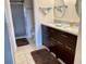 Elegant bathroom with double sink vanity, shower, and ceramic tile floors at 4325 46Th W Ave # 202, Bradenton, FL 34210