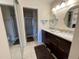 Bathroom featuring a double vanity, modern lighting, and separate shower at 4325 46Th W Ave # 202, Bradenton, FL 34210