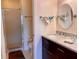 Well-lit bathroom featuring a walk-in shower and a dark vanity with a beautiful marble countertop at 4325 46Th W Ave # 202, Bradenton, FL 34210