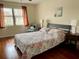 Well-lit bedroom featuring hardwood floors, ample natural light, and cozy decor at 4325 46Th W Ave # 202, Bradenton, FL 34210
