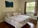 Bedroom with a large window, curtains, and a bed with a patterned bedspread at 4325 46Th W Ave # 202, Bradenton, FL 34210