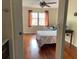 Bedroom featuring a large window with hardwood floors, curtains and a ceiling fan at 4325 46Th W Ave # 202, Bradenton, FL 34210