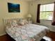 Bedroom with a large window, curtains, and a bed with a patterned bedspread at 4325 46Th W Ave # 202, Bradenton, FL 34210