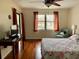 Bedroom with a large window, curtains, chair and a side table with a lamp at 4325 46Th W Ave # 202, Bradenton, FL 34210