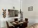 Bright dining area featuring a dark wood table, seating for four, and decorative lighting at 4325 46Th W Ave # 202, Bradenton, FL 34210