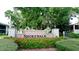 Brick Shorewalk community sign surrounded by vibrant red flowers and lush greenery at 4325 46Th W Ave # 202, Bradenton, FL 34210