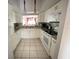 Updated kitchen with white cabinetry, granite countertops, and modern appliances at 4325 46Th W Ave # 202, Bradenton, FL 34210