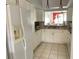 Well-lit kitchen features white cabinets, granite countertops, stainless steel appliances, and tile flooring at 4325 46Th W Ave # 202, Bradenton, FL 34210