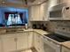 Open kitchen with white appliances, granite countertops, and a view of the living space at 4325 46Th W Ave # 202, Bradenton, FL 34210