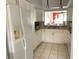 Well-lit kitchen features white cabinets, granite countertops, stainless steel appliances, and tile flooring at 4325 46Th W Ave # 202, Bradenton, FL 34210