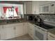 Bright kitchen featuring stainless appliances, granite counters, and a stylish backsplash at 4325 46Th W Ave # 202, Bradenton, FL 34210
