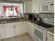 Bright kitchen featuring stainless appliances, granite counters, and a stylish backsplash at 4325 46Th W Ave # 202, Bradenton, FL 34210