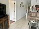 Open-concept living room with neutral decor, tile flooring, and seamless flow to other living spaces in the condo at 4325 46Th W Ave # 202, Bradenton, FL 34210
