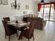 Cozy living and dining area featuring tile floors, neutral paint, comfortable seating, and natural light at 4325 46Th W Ave # 202, Bradenton, FL 34210
