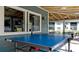 Outdoor patio area featuring a ping pong table, seating area, and exterior windows at 4325 46Th W Ave # 202, Bradenton, FL 34210