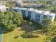 Aerial of condo with trees and tennis court at 4440 Ironwood Cir # 508D, Bradenton, FL 34209