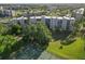 Overhead view of a multi-story condo building with surrounding landscaping and a tennis court at 4440 Ironwood Cir # 508D, Bradenton, FL 34209