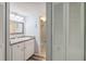 Bathroom with vanity, framed mirror, and enclosed shower behind the door at 4440 Ironwood Cir # 508D, Bradenton, FL 34209