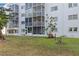 Exterior of building features screened-in balconies and a well-maintained lawn area at 4440 Ironwood Cir # 508D, Bradenton, FL 34209
