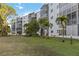 Building exterior with multiple units, balconies, and palm trees in a landscaped setting at 4440 Ironwood Cir # 508D, Bradenton, FL 34209