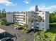 Exterior aerial view of condo building with parking, landscaping, and multiple balconies at 4440 Ironwood Cir # 508D, Bradenton, FL 34209