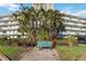 Beautiful condo building featuring a welcoming bench, lush landscaping, and secure parking at 4440 Ironwood Cir # 508D, Bradenton, FL 34209