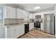Bright kitchen features stainless steel appliances, granite countertops, and white cabinets at 4440 Ironwood Cir # 508D, Bradenton, FL 34209