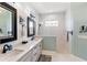 Well-appointed bathroom featuring double sinks, stylish mirrors, and a walk-in shower with modern fixtures at 4625 Foxtail Dr, Parrish, FL 34219