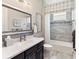 Modern bathroom features a large mirror, stylish vanity, and tiled shower with tub at 4625 Foxtail Dr, Parrish, FL 34219