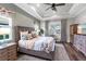 Comfortable bedroom with decorative ceiling, stylish furniture, and natural light at 4625 Foxtail Dr, Parrish, FL 34219
