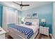 Comfortable bedroom with soft blue walls, white furniture, and stylish beach-themed decor at 4625 Foxtail Dr, Parrish, FL 34219
