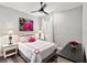 Bright bedroom with a bed with bright pink trim, decor, and matching bedside lamps at 4625 Foxtail Dr, Parrish, FL 34219