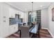 Dining room features stylish light fixture, large windows, and custom cabinets with tiled backsplash at 4625 Foxtail Dr, Parrish, FL 34219
