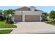 Charming home featuring a spacious three-car garage and meticulously maintained landscaping at 4625 Foxtail Dr, Parrish, FL 34219