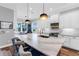 Kitchen with white cabinetry, marble countertops, stainless appliances, a center island and seating for three at 4625 Foxtail Dr, Parrish, FL 34219
