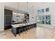 Kitchen with large island, breakfast bar, and elegant accent wall at 4625 Foxtail Dr, Parrish, FL 34219