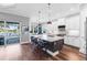 Modern kitchen with a large center island, counter seating, and a view of the lake through sliding glass doors at 4625 Foxtail Dr, Parrish, FL 34219