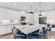 Bright kitchen features a large center island, stainless steel appliances, and stylish pendant lighting at 4625 Foxtail Dr, Parrish, FL 34219