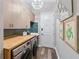 Laundry room with wood countertop, cabinets, mosaic backsplash, and decor at 4625 Foxtail Dr, Parrish, FL 34219