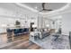 Open-concept living room showcasing a stylish kitchen, hardwood flooring and natural light at 4625 Foxtail Dr, Parrish, FL 34219